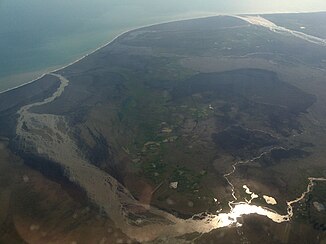 The mouth of Skaftá in the Atlantic Ocean, with the flat estuary Landbrot (left, front) and Eldhraun (right, back)