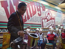 A magician entertaining children at a Wendy's restaurant in Jakarta, Indonesia during a birthday party. Mall culture jakarta76.jpg