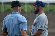 Mike Hauschild (right) talks to an umpire after having been called for a balk Mike Hauschild (44117497882).jpg