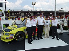 Toyota executives in front of the truck that won Toyota's first national series race. Nascar 1st Win executives.jpg