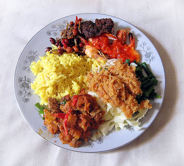 Nasi kuning with urap, fried beef, anchovy and peanuts, potato and shrimp in sambal.
