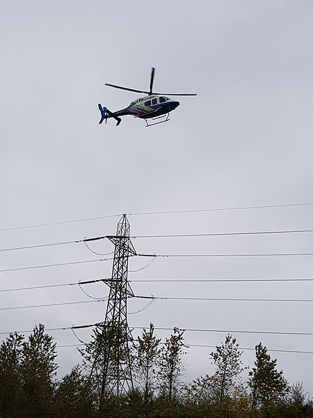 National Grid helicopter inspecting overhead cables in Greater Manchester