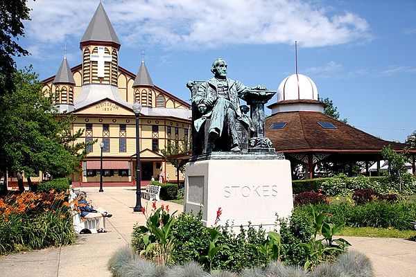 A statue of Ellwood H. Stokes and the Great Auditorium facing Ocean Pathway – once named one of the ten most beautiful streets in America