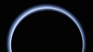 Haze of the atmosphere of Pluto.