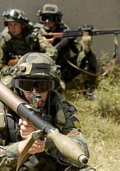 A Bulgarian soldier aims an RPG. RPG soldier and squad.jpg