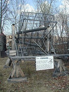 Fish wheel on display in Alaska. The sign reads that fish wheels originated in Scandinavia and were brought to Alaska by a man from Ohio in the late 1800s, but there is still debate over the wheel's origins RV02Interior28.JPG