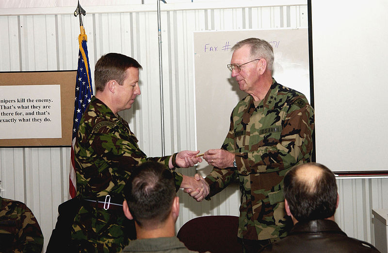 File:Royal Air Force Wing Commander David M. Beckwith is presented a specially engraved bullet by US Army Major General Don C. Morrow, Adjutant General for the State of Arkansas.jpg