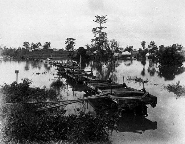 Makeshift bridge of railway wagons during the 1890 flood between Milton and Auchenflower to allow passengers to reach the city. This photograph was ta