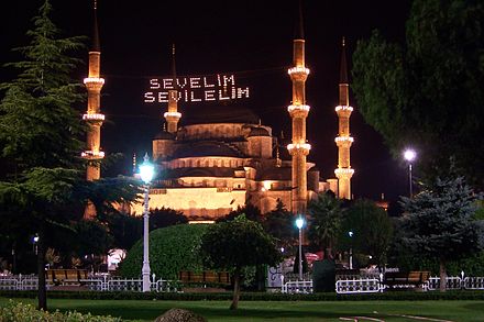 Traditional Bayram wishes from the Istanbul Metropolitan Municipality, stating "Let us love, Let us be loved", in the form of mahya lights stretched across the minarets of the Blue Mosque in Istanbul
