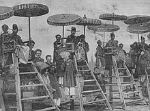 Invigilators seated on high chairs at a provincial exam in 1888 in northern Vietnam ThiHuong1888.jpg