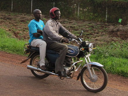 Boda-boda with, rather unusually, a helmeted pilot - no helmet is provided for his fearless fare, of course...