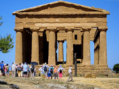 Tourists in front of the Temple of Concordia in the Valley of the Temples in Agrigento, Sicily, Italy