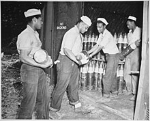 "Enlisted men serving on Espiritu Santo in the New Hebrides... placing 6-inch shells in magazines at the Naval Ammunition" - NARA - 520631 "Enlisted men serving on Espiritu Santo in the New Hebrides...placing 6-inch shells in magazines at the Naval Ammunition - NARA - 520631.jpg