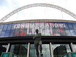 'Congratulations Leigh' signage behind the statue of Bobby Moore at Wembley Stadium following the 2023 Challenge Cup Final.