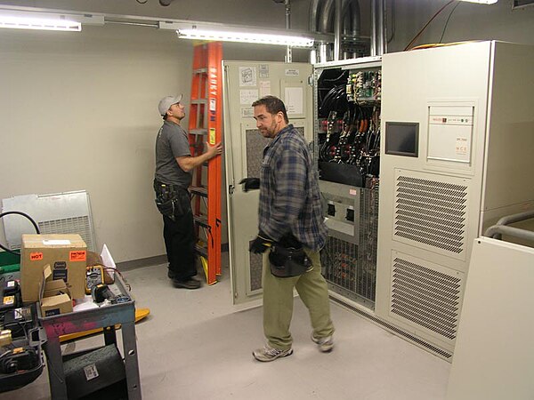 A large data-center-scale UPS being installed by electricians