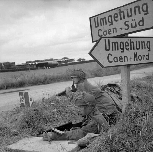 Two soldiers of the 6th Airborne Division man a trench beside the Caen road just outside Ranville