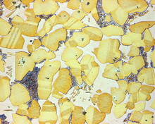 Metallography allows the metallurgist to study the microstructure of metals. AlubronzeCuAl20v500.png