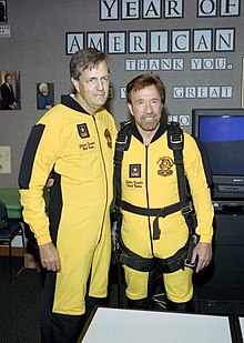 Brit Hume and Chuck Norris pose in the George Bush Presidential Library Classroom in College Station, Texas, at President Bush's 80th birthday celebration