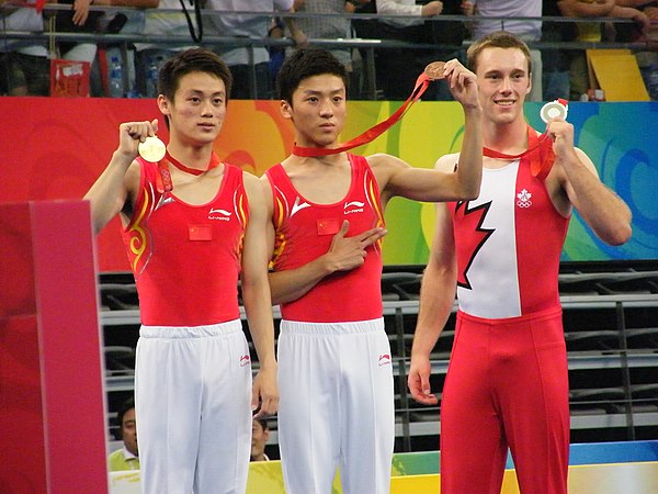 Left to right: Lu Chunlong (gold), Dong Dong (bronze), both from China, and Jason Burnett from Canada (silver) won medals in the men's trampoline gymn