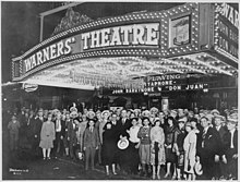 Movie-goers awaiting Don Juan opening at Warners' Theatre First-nighters posing for the camera outside the Warners' Theater before the premiere of "Don Juan" with John Barrymore, - NARA - 535750.jpg
