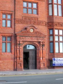 The doorway of the restored Florence Institute in December 2014 Florence Institute 2014 Detail.png