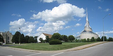 View east-northeastward of the "Hedrickite" Temple Lot today. The 2.5-acre "block" shown is the highest-elevation part of a 63.5-acre piece of real estate which has variously been referred to (also) as the "Temple Lot" or "Mormon Temple Lot" or "Temple Parcel" or "Temple Block" or "Temple Property" or "Greater Temple Lot", purchased by Edward Partridge on December 19, 1831. The portion shown in this photograph was re-purchased on behalf of trustee Granville Hedrick between 1867 and 1877. HedrickiteTempleLotWithCofChristBuildingsNearby.jpg