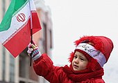 Child with the Islamic Republic flag during the 38th anniversary of the Iranian Revolution.