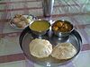 Traditional Bengali breakfast comprising of ''luchi'' with ''alur dom'', ''dal'' and ''sôndesh''.