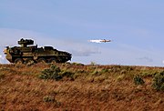 M1134 ATGM Vehicle fires TOW missile