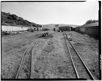 OVERALL VIEW OF MINE SITE, SHOWING MINE CAR TRACKS, SNOWSHEDS AND TIPPLE (LEFT BACKGROUND).  VIEW TO EAST.  - Park Utah Mining Company- Keetley Mine Complex, 1 mile East of US HAER UTAH, 26-HEBCI.V, 3-4.tif