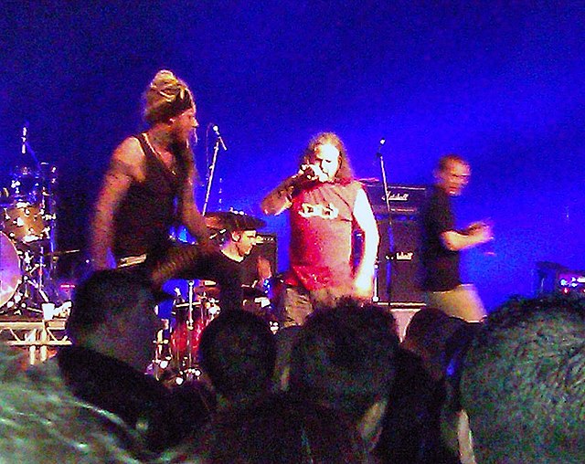 The 2012 incarnation of Pop Will Eat Itself performing live in Birmingham. Left to right: Davey Bennett (bass), Jason Bowld (drums), Graham Crabb (voc