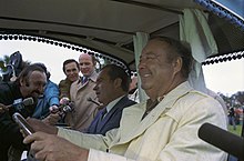 President Richard Nixon and Jackie Gleason in a golf cart with an audience in February 1973.