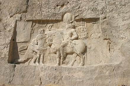 Roman emperor Valerian (left, kneeling) begs for his life after being captured by Persian Shah Shapur I (mounted) at the Battle of Edessa (259), the most humiliating of the military disasters suffered by the empire in the late 3rd century. Rock relief at Naqsh-e Rostam near Shiraz, Iran