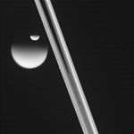 Saturnus måne Dione passerar en annan av Saturnus månar Titan. Sett från observatoriet Cassini.
