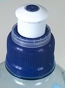 A "sports cap" made of plastic, as seen on many water bottles, here seen in closed configuration.