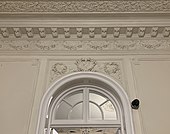 Semicircular window above a door in the D.A. Sturdza House, from Bucharest, above it being various stucco ornaments