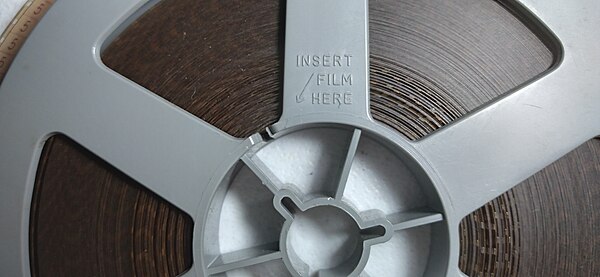 Super 8 spool with film - detail "Insert film here"