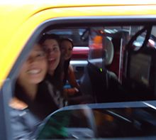 A taxicab starting to drive off blurred the girls' faces in the image. Three women in a taxi in Manhattan who said hello.jpg