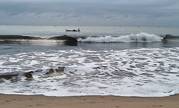 Tiny boat riding the Waves