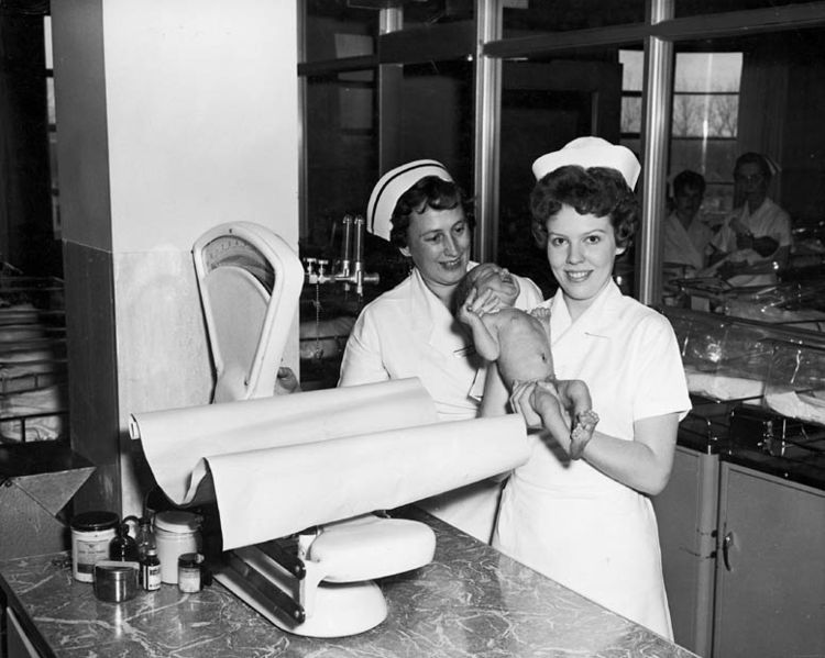 File:Two nurses with baby in nursery at Toronto East General and Orthopaedic Hospital, Toronto, ON.jpg