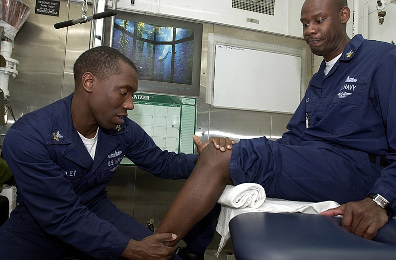 File:US Navy 020128-N-6077T-008 CVN 74 crew member receives medical treatment aboard ship.jpg