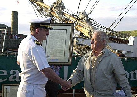 Captain Michael Gordon, USN, receives in 2005 a copy of the local newspaper from April 1778 from the chairman of the Whitehaven Harbour Commissioners, Gordon Thomson