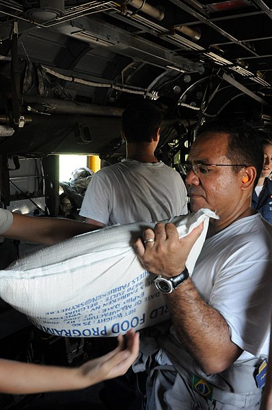 File:US Navy 080917-N-5642P-104 t. Cmdr. Thomas Carmos helps load a CH-53 Super Stallion with disaster relief supplies.jpg