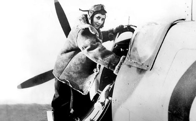 Diana Barnato Walker climbing into the cockpit of a Spitfire