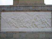 People of Wuhan fighting the flood, as depicted on the monument in Hankou. The text on the placard they carry, "Yi Bu Pa Ku ,Er Bu Pa Si 
" ("First, don't fear hardships; second, don't fear death") is said to be a Chinese Red Army's saying from the times of the Chinese Civil War; it was used by Mao Zedong in an April 1969 speech. Wuhan-Flood-Memorial-0229.jpg