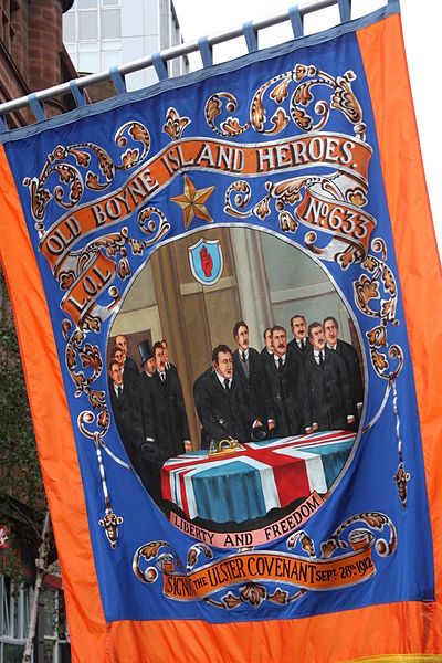 An Orange banner showing the signing of the Ulster Covenant