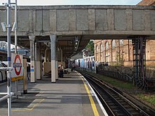 Eastbound District line platform looking west with the remains of the branch on the right Acton Town stn eastbound District look west.JPG