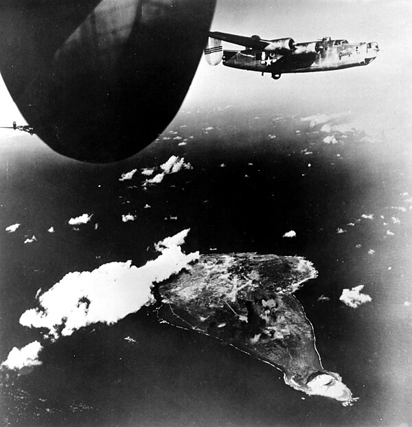 B-24 Liberators fly away from Iwo Jima after bombing the island on December 15, 1944