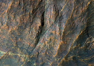 Banded bedrock in Terra Sabaea, in the ancient highlands north of the Hellas basin. The image is about a kilometer wide. Colors are enhanced.