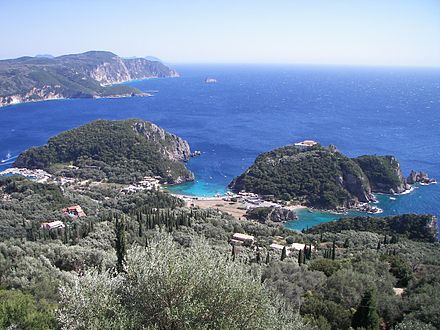 The bay of Palaiokastritsa in Corfu as seen from Bella vista of Lakones. Corfu is considered to be the mythical island of the Phaeacians. The bay of Palaiokastritsa is considered to be the place where Odysseus disembarked and met Nausicaa for the first time. The rock in the sea visible near the horizon at the top centre-left of the picture is considered by the locals to be the mythical petrified ship of Odysseus. The side of the rock toward the mainland is curved in such a way as to resemble the extended sail of a trireme.